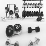 A set of sports dumbbells and pancakes on the racks