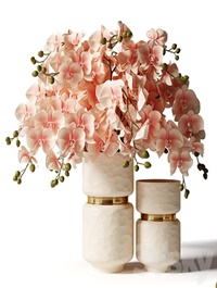 Bouquet of pink orchids in a modern beige vase
